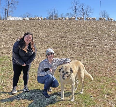 Two members of the Ohio Coyote Team with a livestock guard dog